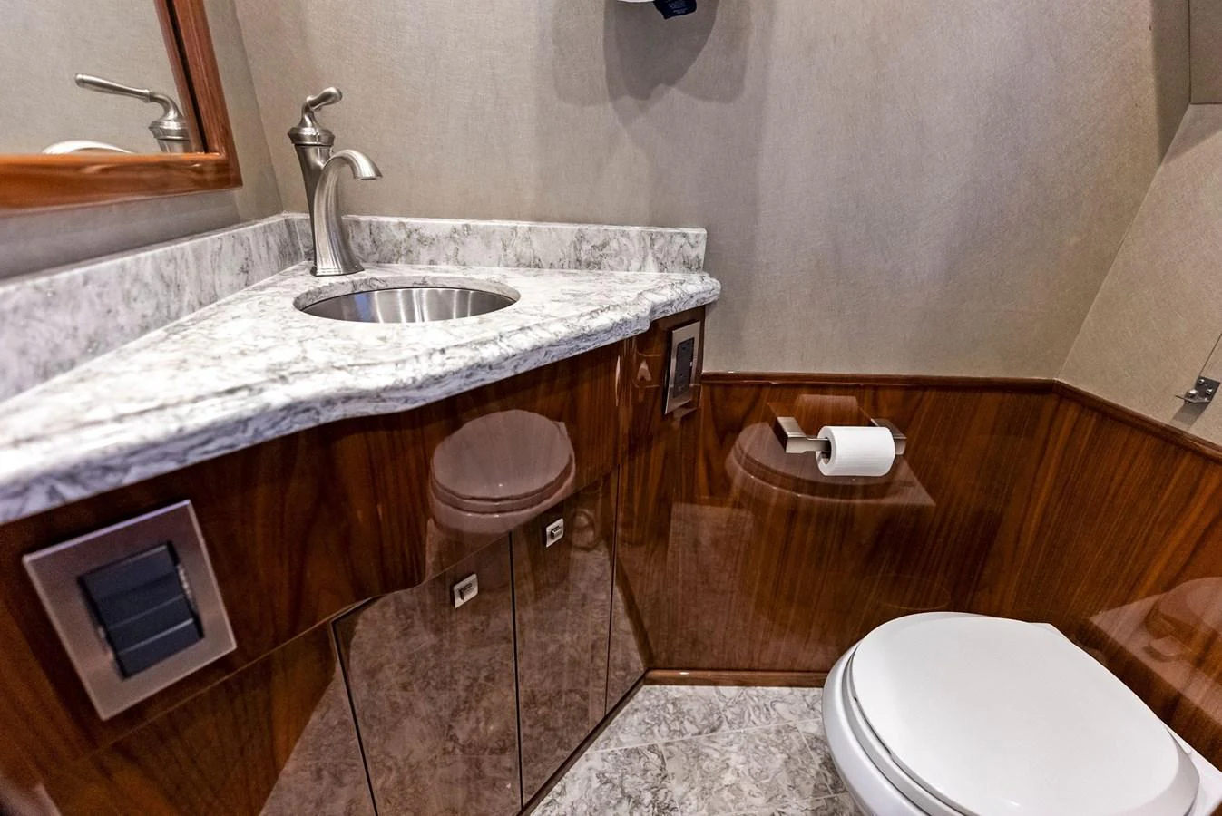 The yacht's head features a sleek sink with a marble countertop and modern fixtures. aboard CATCH 23 Yacht for Sale