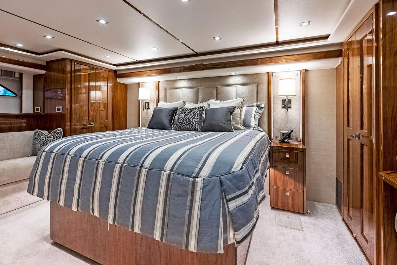 The master stateroom features a luxurious bed with plush bedding and elegant wood paneling. aboard CATCH 23 Yacht for Sale