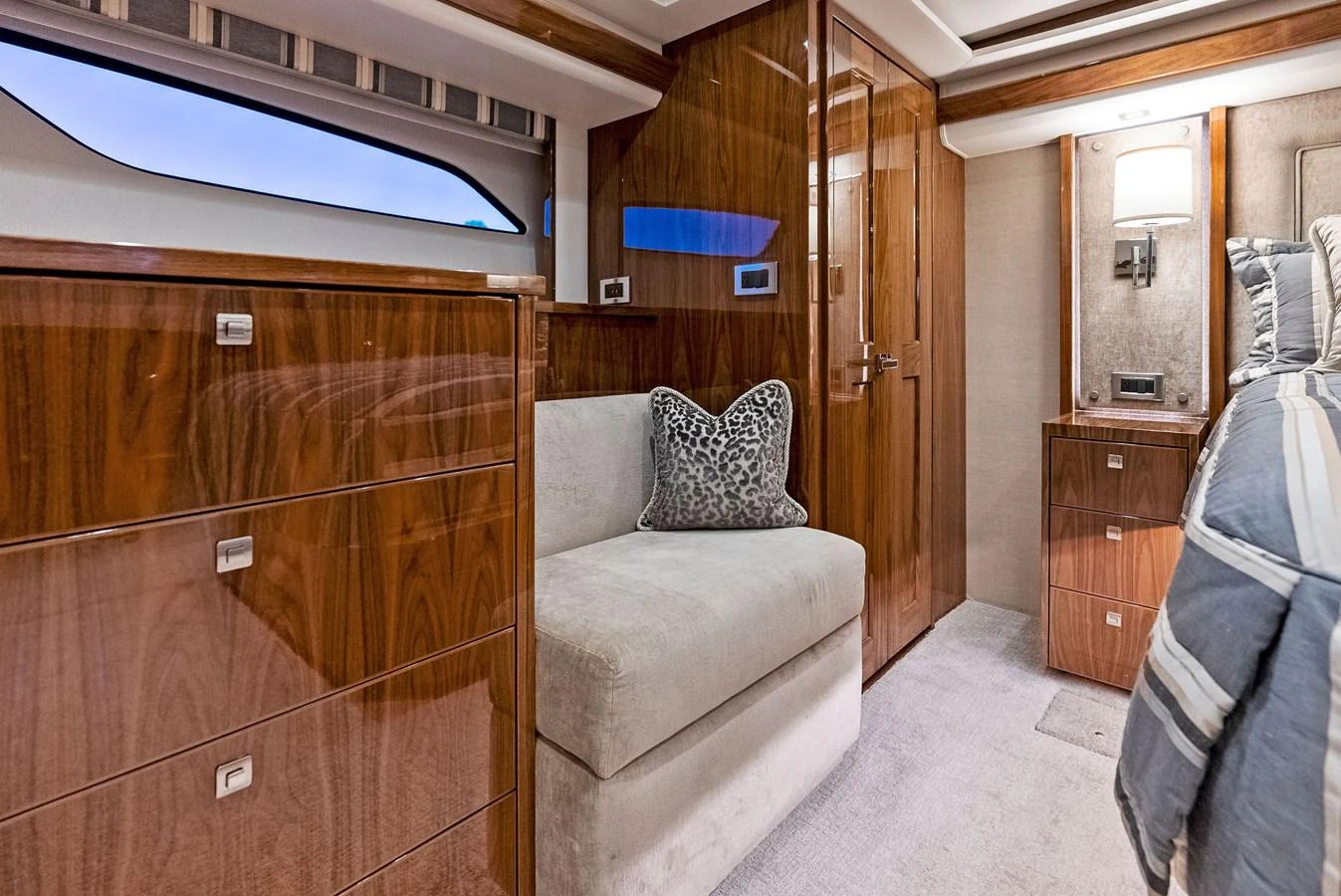The yacht's interior features a cozy seating area with elegant wooden cabinetry and modern lighting. aboard CATCH 23 Yacht for Sale