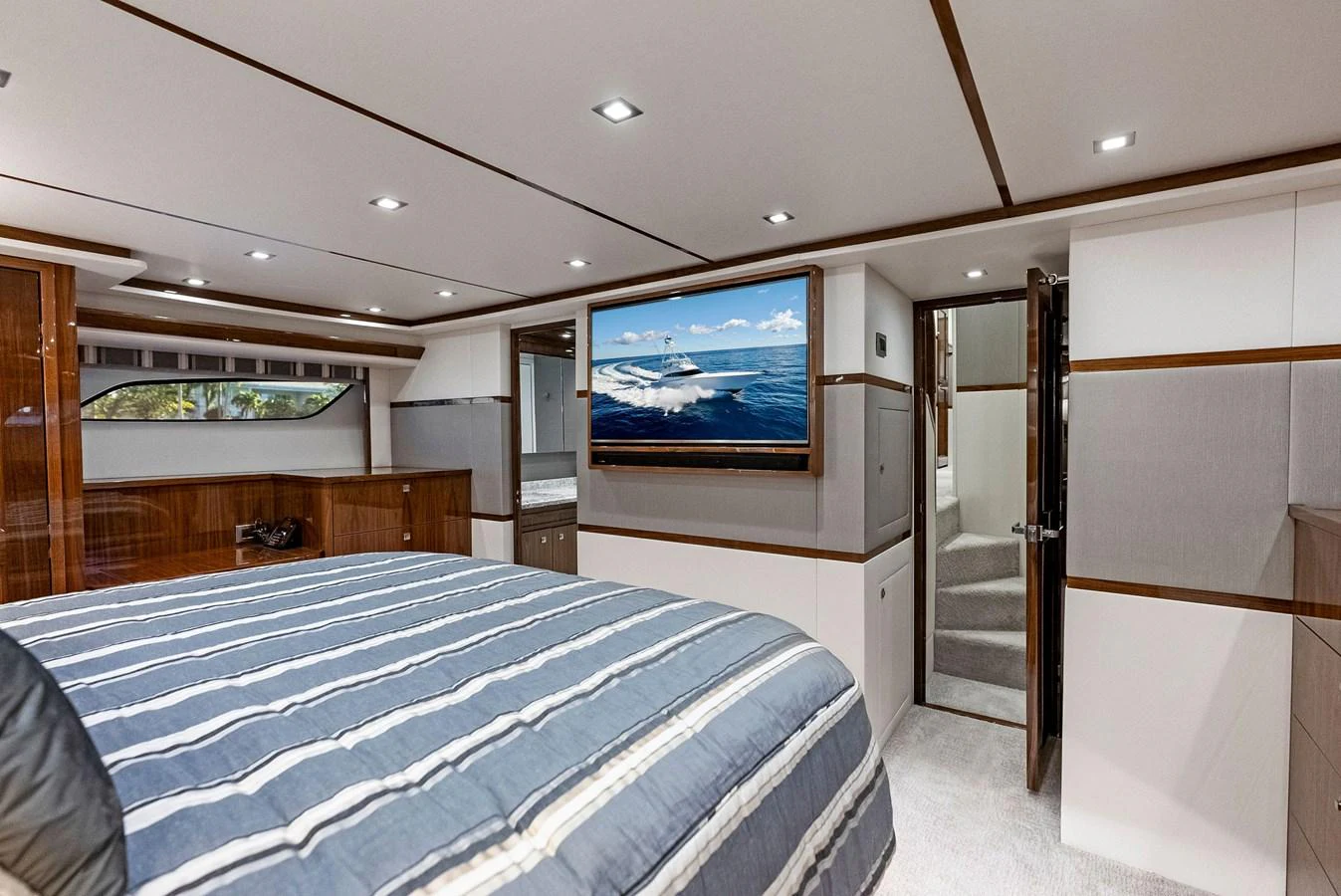The master stateroom features a plush bed, ample storage, and a large TV for ultimate relaxation. aboard CATCH 23 Yacht for Sale