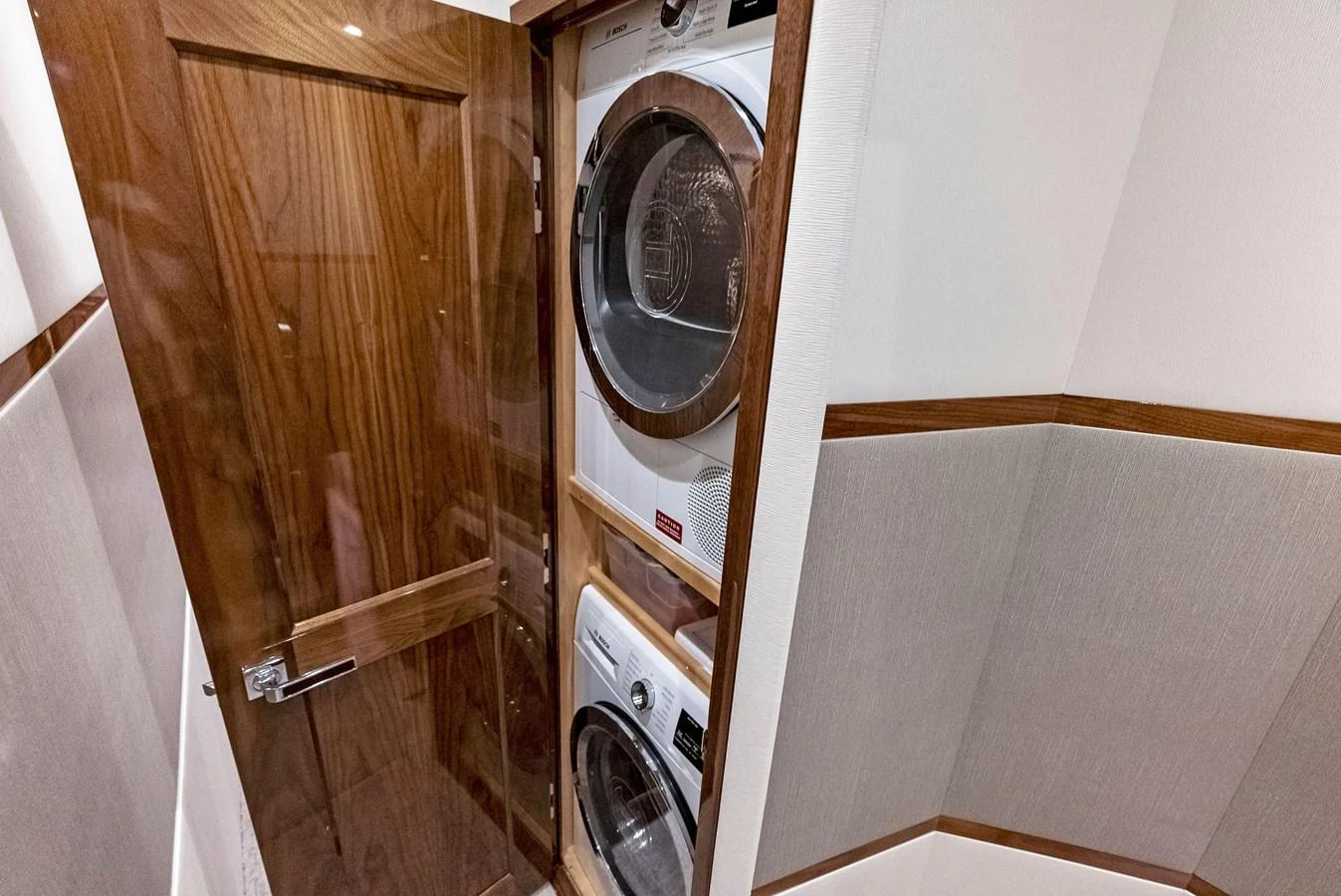 The yacht features a compact and efficient laundry area with modern appliances. aboard CATCH 23 Yacht for Sale