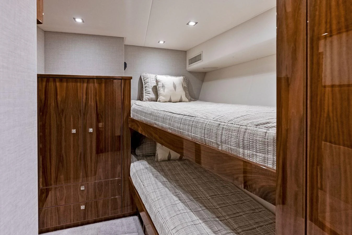 A cozy guest cabin with wooden finishes and bunk beds. aboard CATCH 23 Yacht for Sale