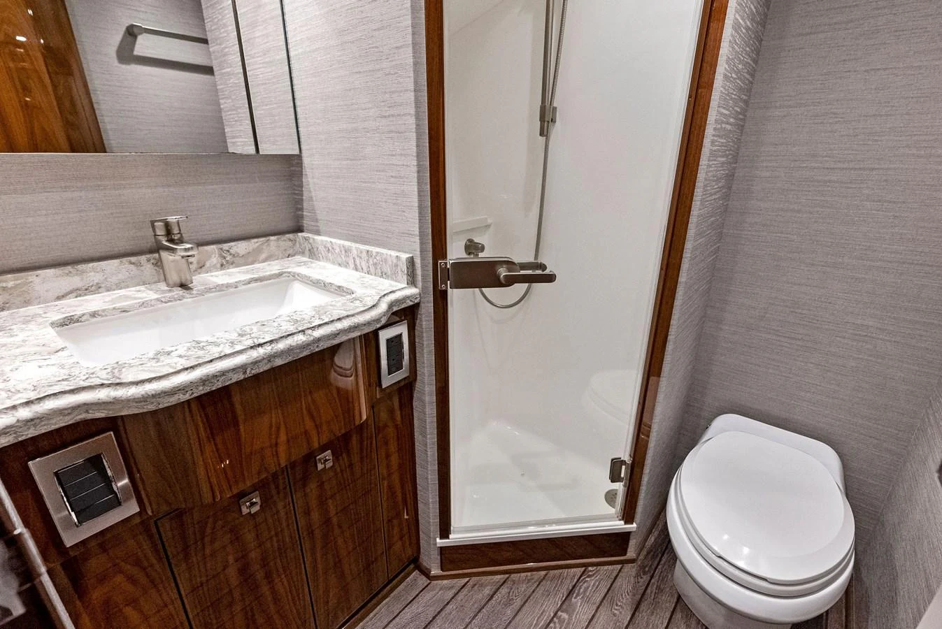 The yacht's bathroom features a sleek design with a marble countertop and a glass-enclosed shower. aboard CATCH 23 Yacht for Sale