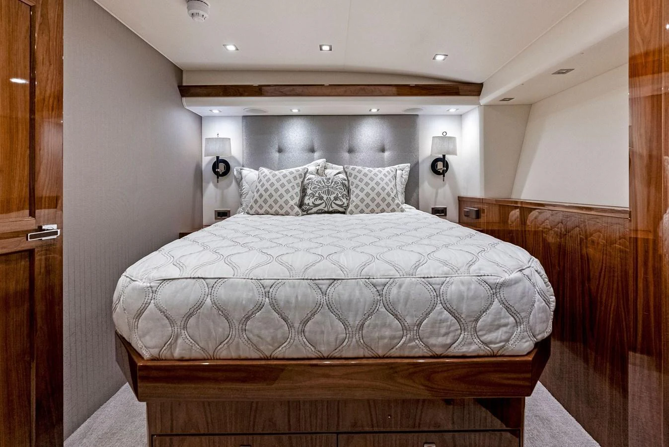 The stateroom features a luxurious bed with elegant bedding and polished wood finishes. aboard CATCH 23 Yacht for Sale
