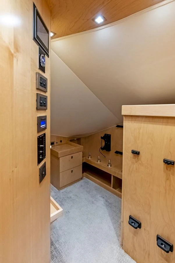 A cozy interior space with light wood paneling and modern fixtures. aboard CATCH 23 Yacht for Sale