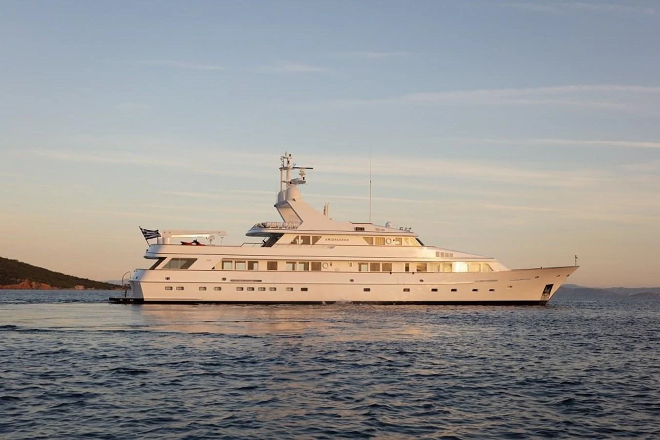 A stunning yacht glides gracefully on calm waters under a serene sky. aboard KASSANDRA Yacht for Sale