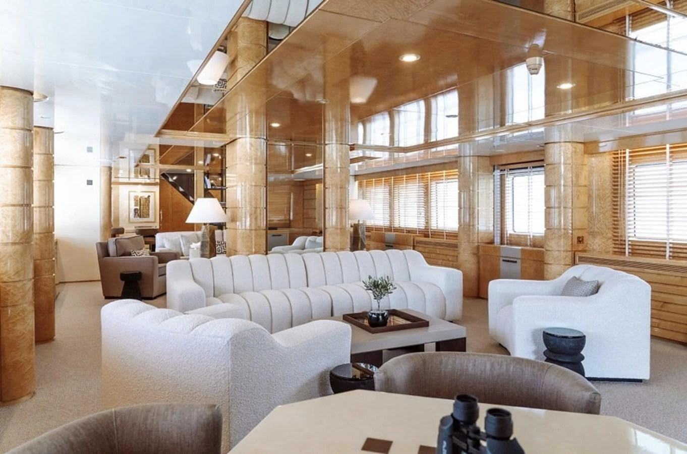 The salon features plush seating and a sophisticated ambiance with ample natural light. aboard KASSANDRA Yacht for Sale