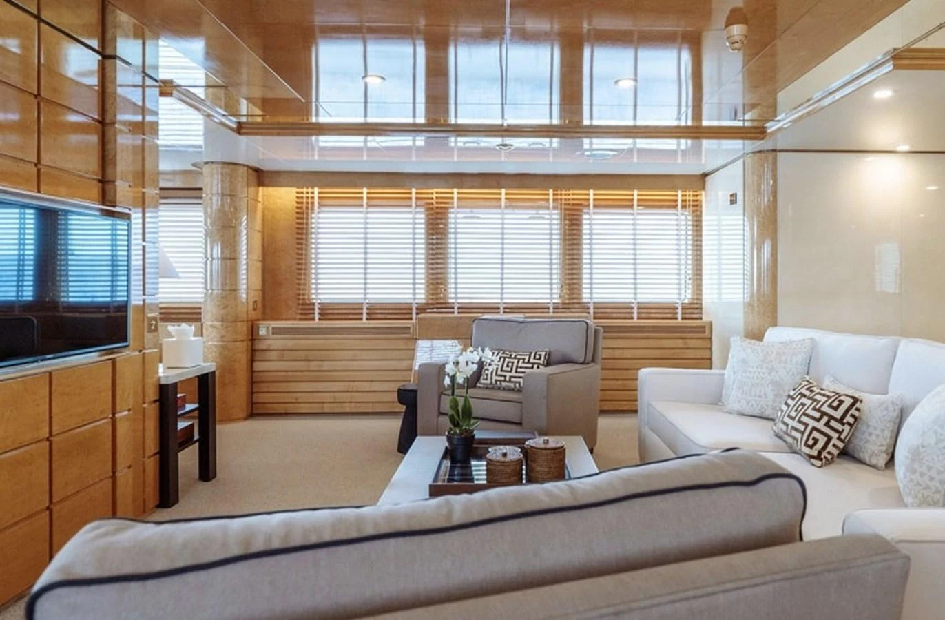 The salon features plush seating and elegant wooden paneling, creating a warm and inviting atmosphere. aboard KASSANDRA Yacht for Sale