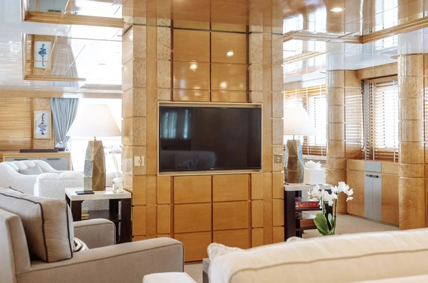 The yacht's interior features a luxurious living area with comfortable seating and a large flat-screen TV. aboard KASSANDRA Yacht for Sale