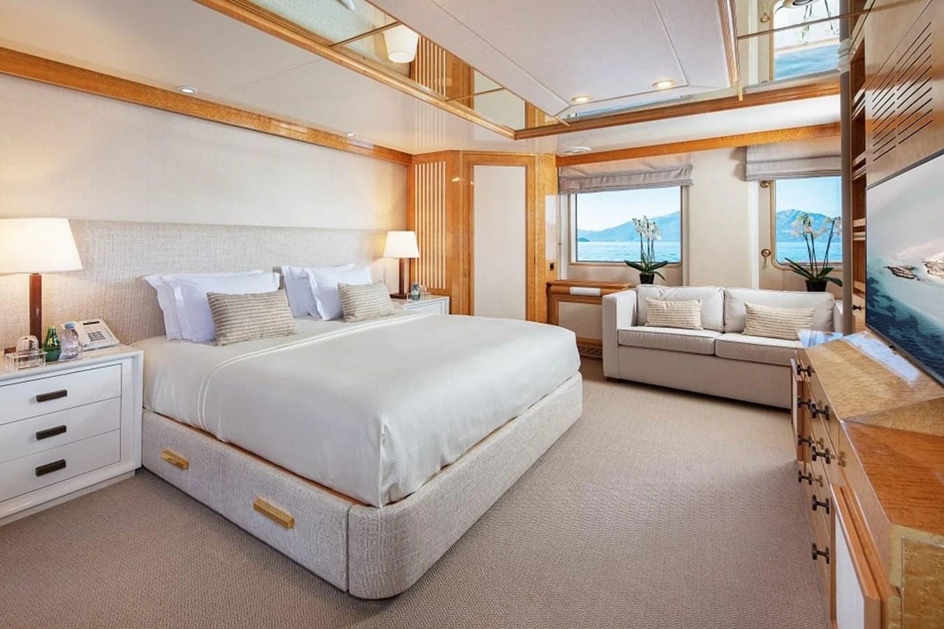 The master stateroom features a spacious bed, elegant decor, and large windows offering stunning ocean views. aboard KASSANDRA Yacht for Sale
