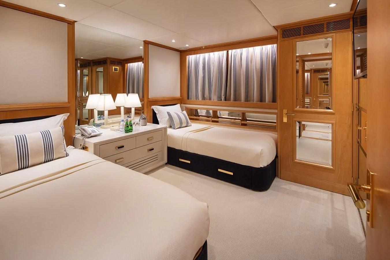 The guest stateroom features twin beds, elegant decor, and ample lighting for a comfortable stay. aboard KASSANDRA Yacht for Sale