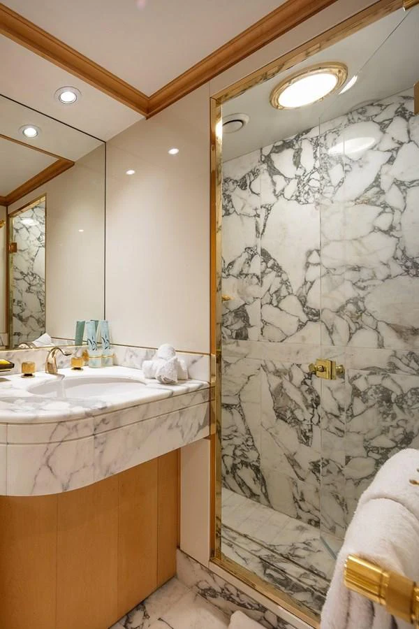 The yacht's bathroom features luxurious marble finishes and elegant fixtures. aboard KASSANDRA Yacht for Sale