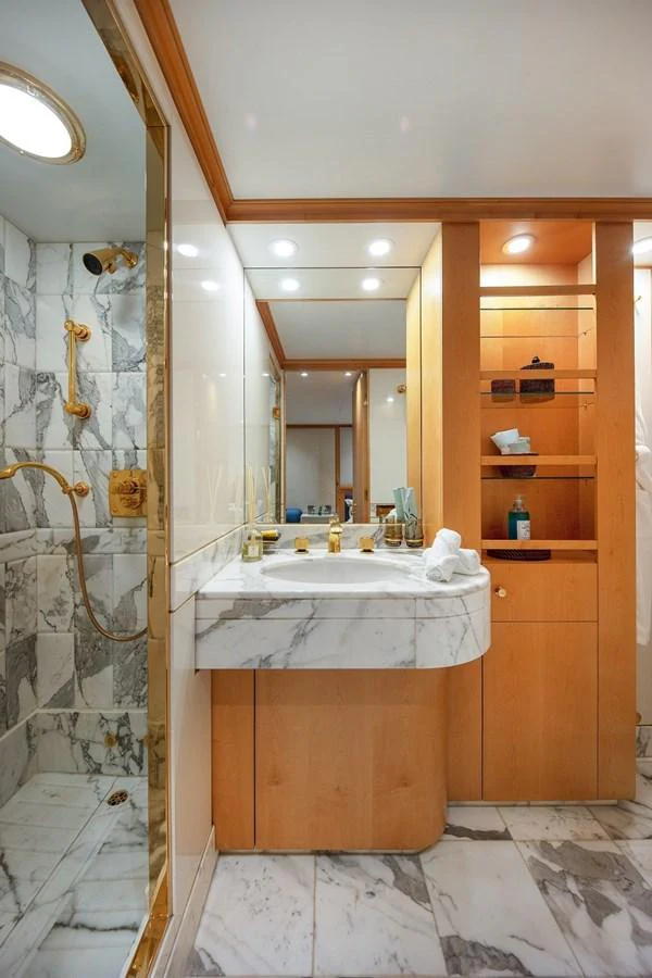A luxurious yacht bathroom featuring marble surfaces and gold fixtures. aboard KASSANDRA Yacht for Sale