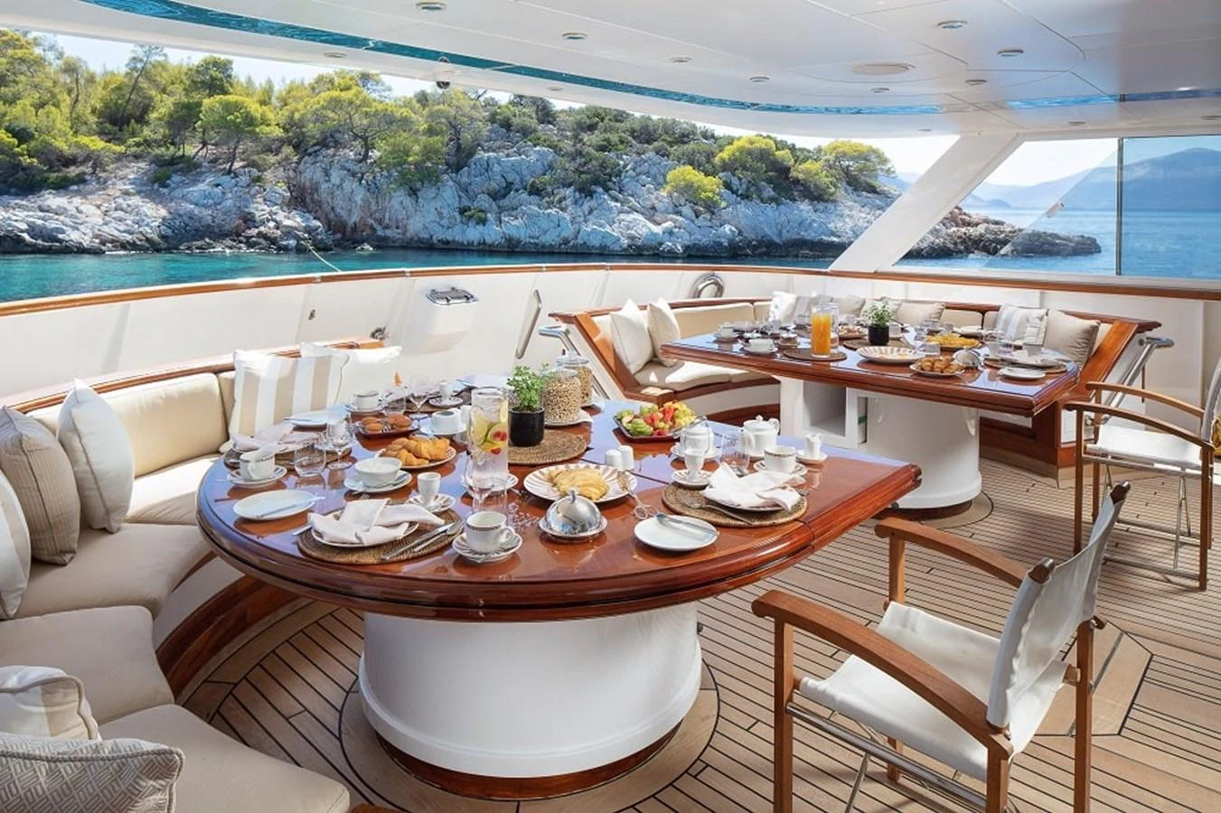 The aft deck offers a luxurious dining experience with a stunning view of the surrounding waters and landscape. aboard KASSANDRA Yacht for Sale