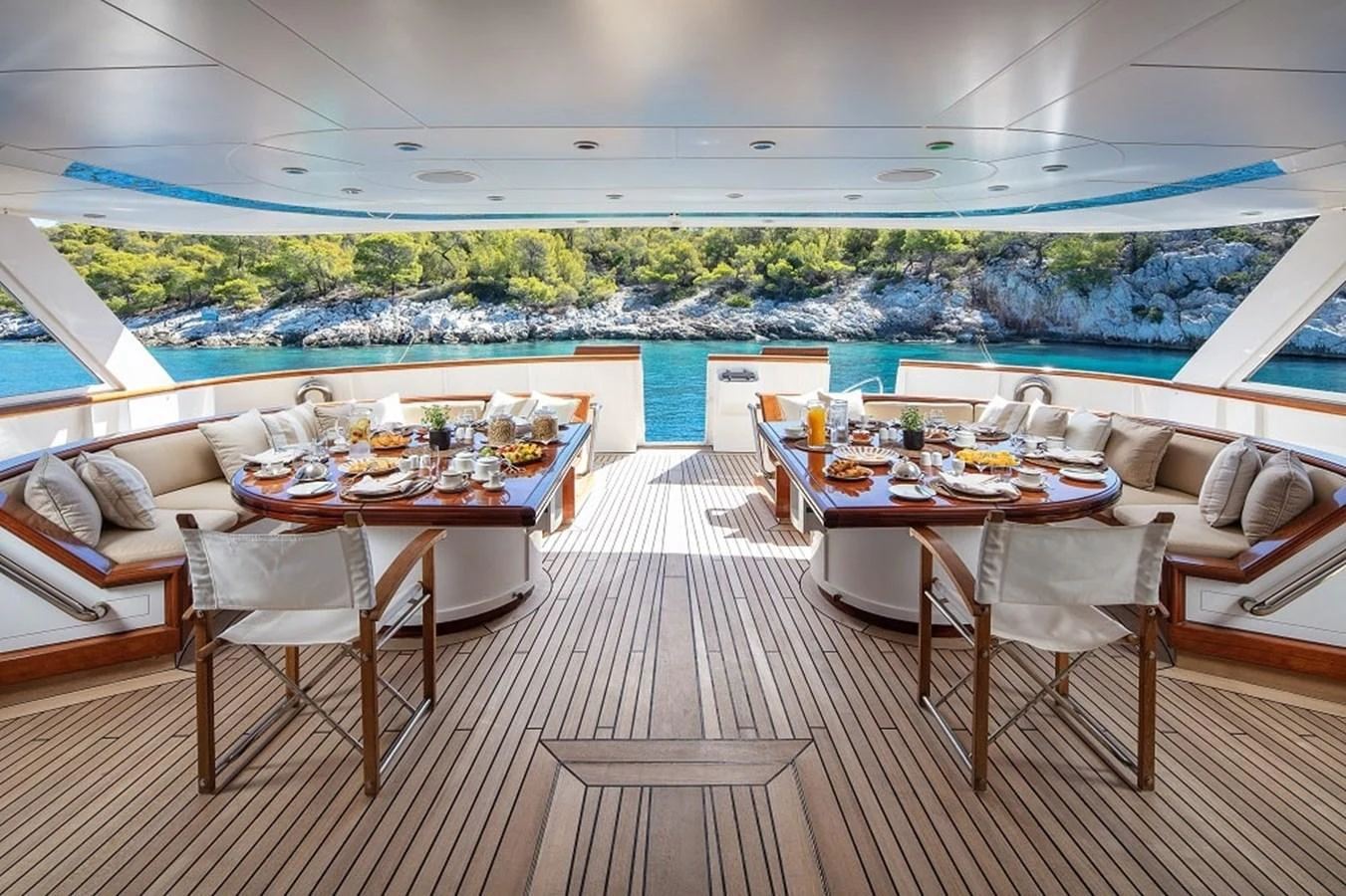 The aft deck features an elegant dining area with stunning views of the surrounding waters. aboard KASSANDRA Yacht for Sale