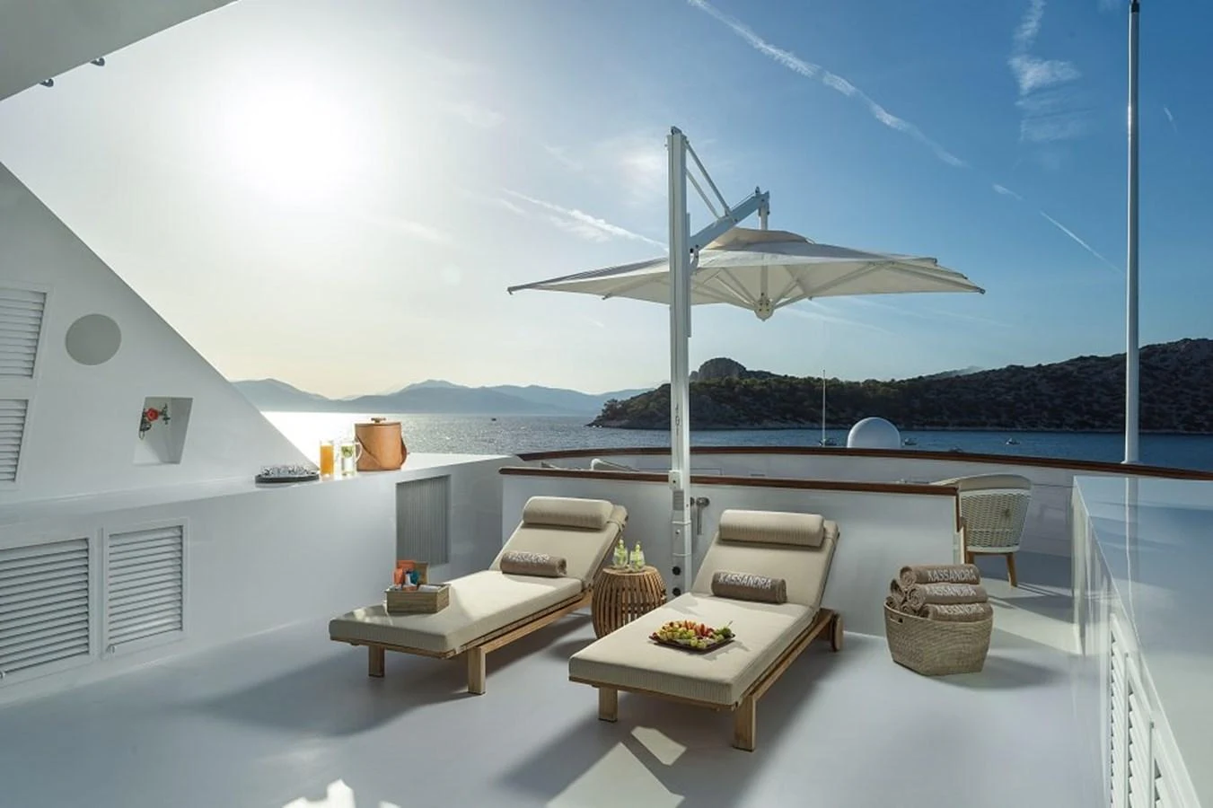 The sundeck offers a serene space with comfortable loungers and a stunning sea view. aboard KASSANDRA Yacht for Sale