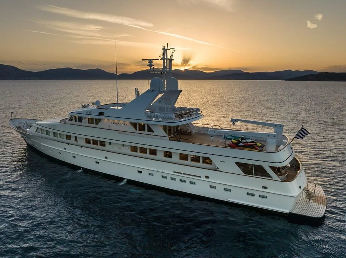 A stunning yacht glides gracefully on the water at sunset, showcasing its elegant design and luxurious amenities. aboard KASSANDRA Yacht for Sale