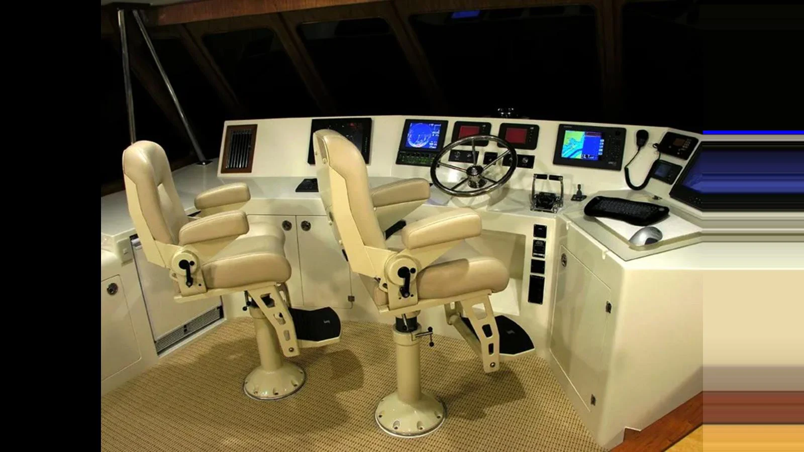The helm features dual captain chairs and an array of navigation equipment. aboard MIKELSON 75 SPORTFISHER Yacht for Sale