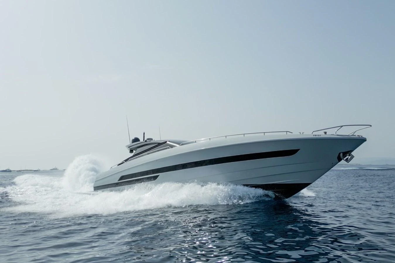 A sleek yacht glides swiftly across the water, showcasing its modern design and powerful performance. aboard BAIA 70 Yacht for Sale