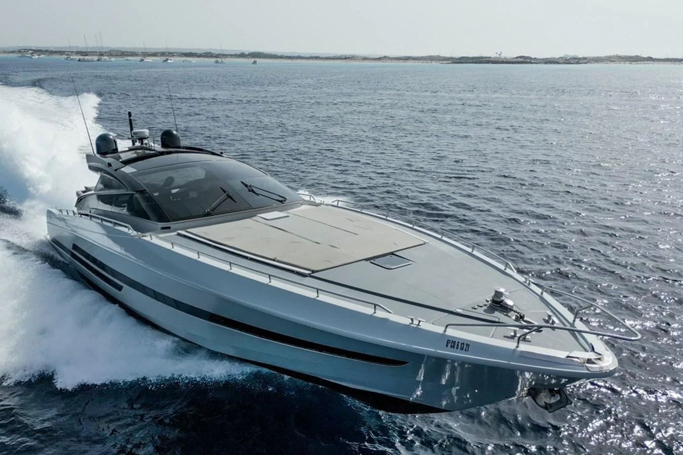 A sleek and modern yacht glides swiftly over the water, showcasing its streamlined design and luxurious appeal. aboard BAIA 70 Yacht for Sale