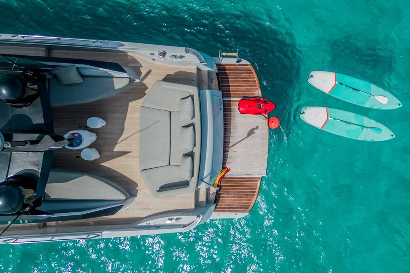 The yacht's aft deck features a spacious lounging area with easy access to water toys. aboard BAIA 70 Yacht for Sale