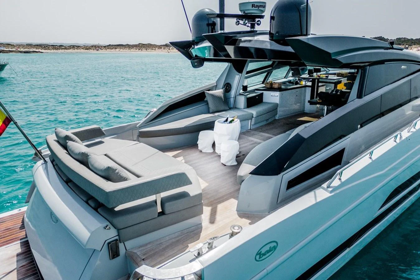 The yacht features a spacious aft deck with luxurious seating and lounging areas, perfect for relaxation and entertainment. aboard BAIA 70 Yacht for Sale