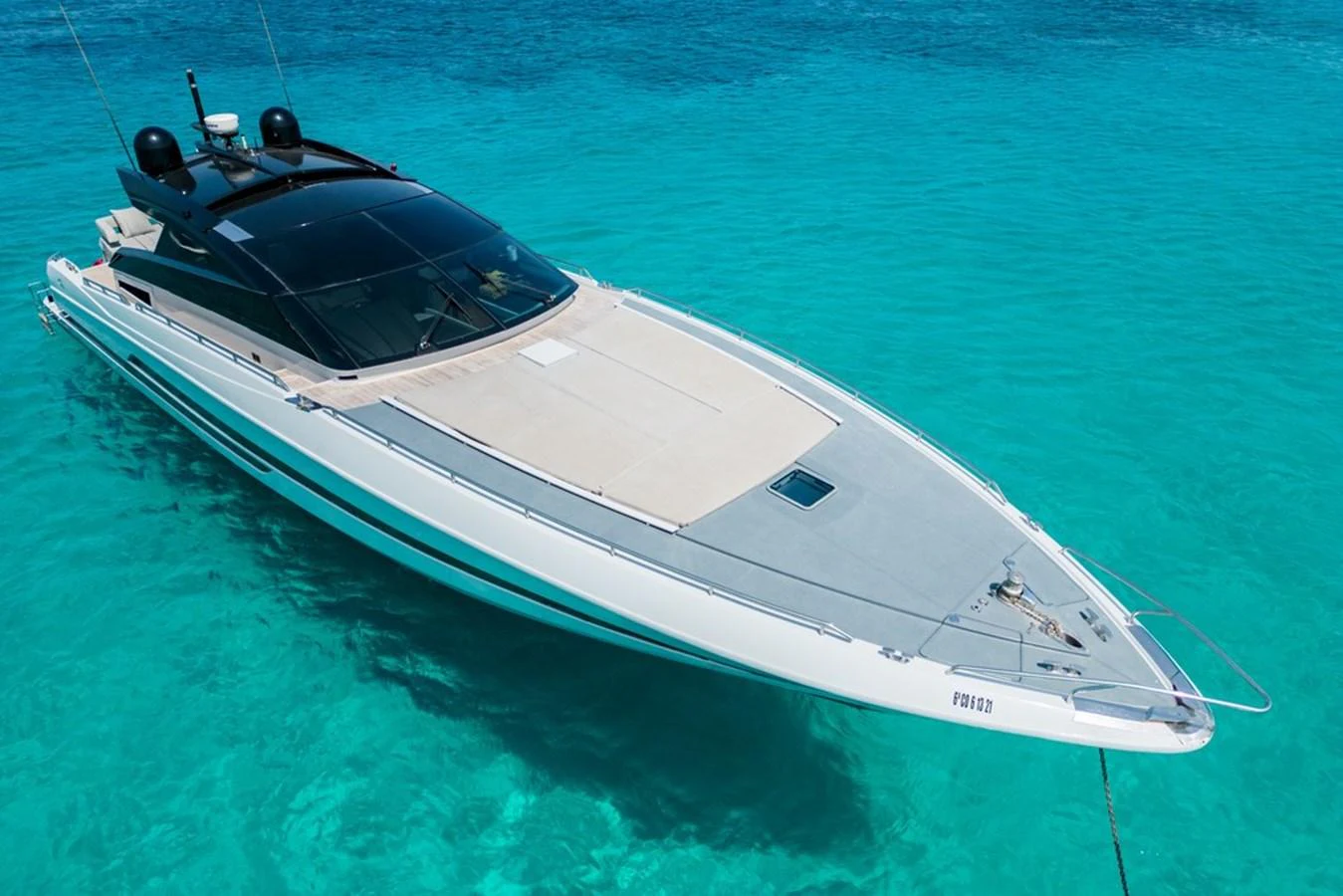 A sleek and modern yacht glides effortlessly on crystal-clear turquoise waters. aboard BAIA 70 Yacht for Sale