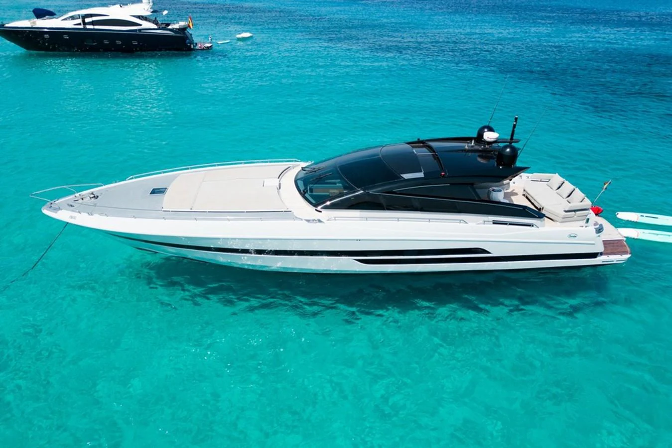 A sleek and modern yacht glides gracefully on crystal-clear turquoise waters. aboard BAIA 70 Yacht for Sale