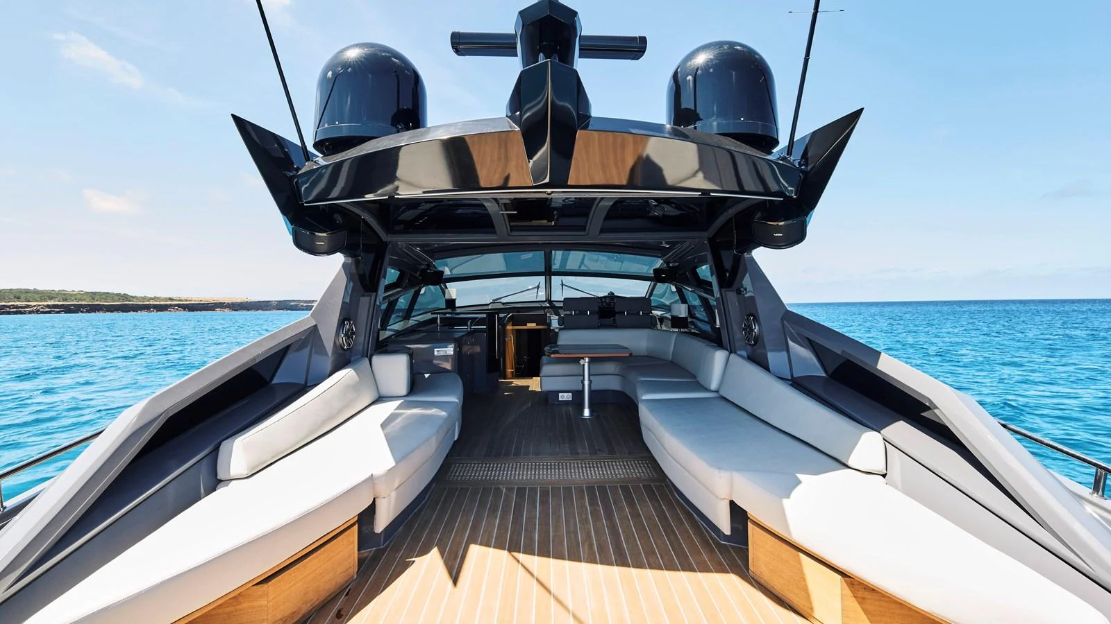 The yacht's aft deck offers a spacious and luxurious seating area with a stunning view of the sea. aboard BAIA 70 Yacht for Sale