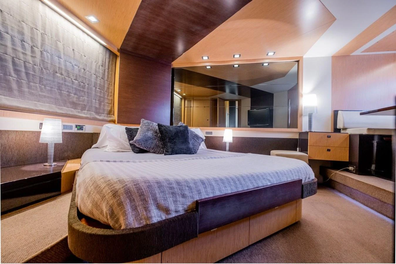 The master stateroom features a luxurious bed with modern decor and ample lighting. aboard BAIA 70 Yacht for Sale
