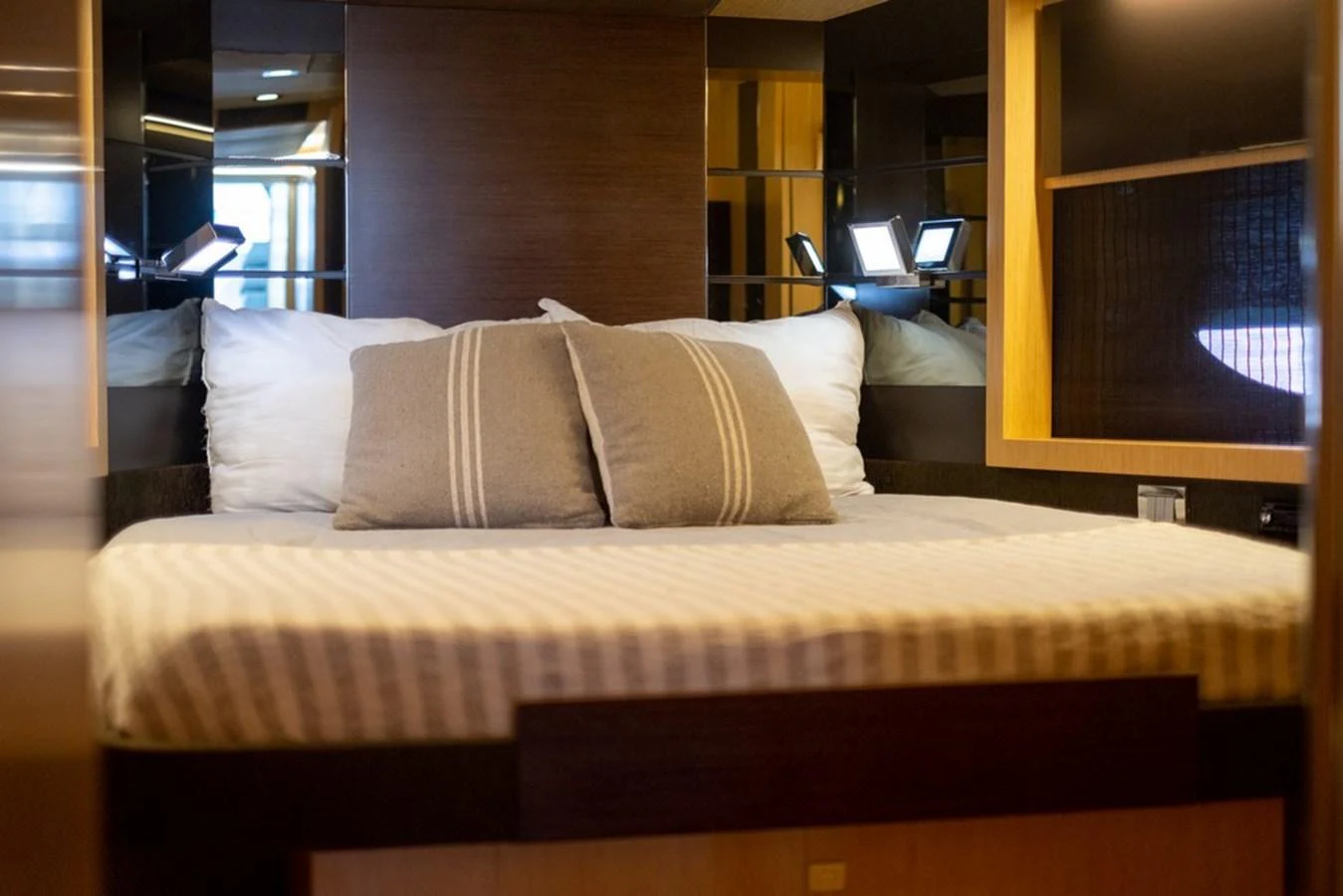 A cozy stateroom with a comfortable bed and soft lighting. aboard BAIA 70 Yacht for Sale