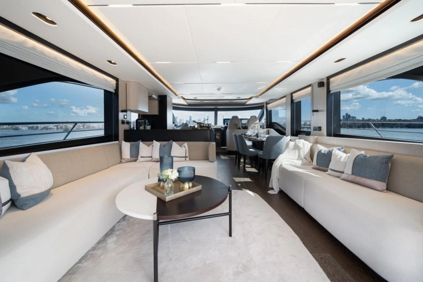 The spacious salon features elegant seating with panoramic views through large windows. aboard TOPAZ Yacht for Sale