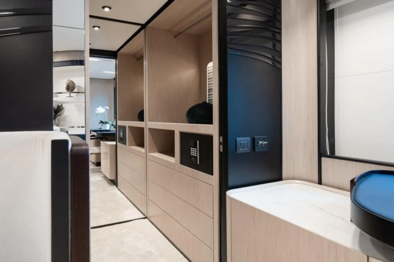The yacht's interior features a modern hallway with sleek storage and elegant design elements. aboard TOPAZ Yacht for Sale