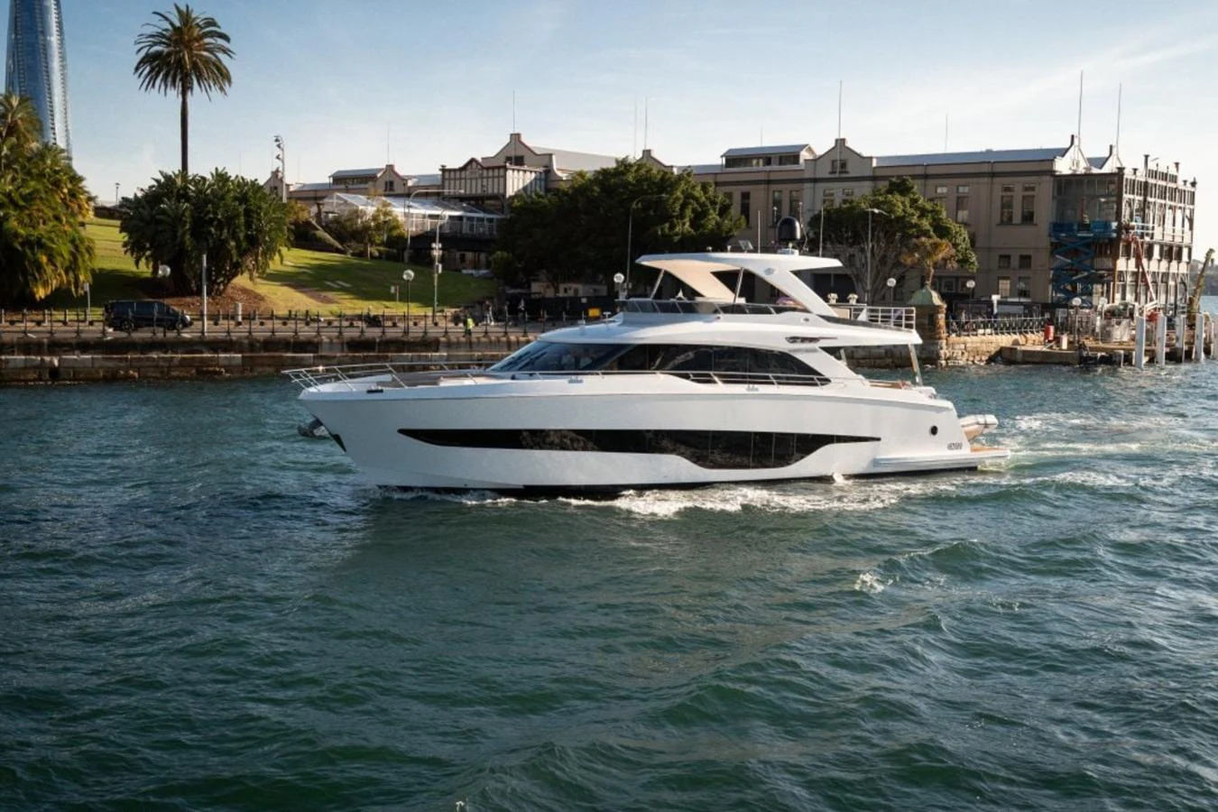 A sleek and modern yacht cruises along the waterfront, showcasing its elegant design and luxurious features. aboard TOPAZ Yacht for Sale