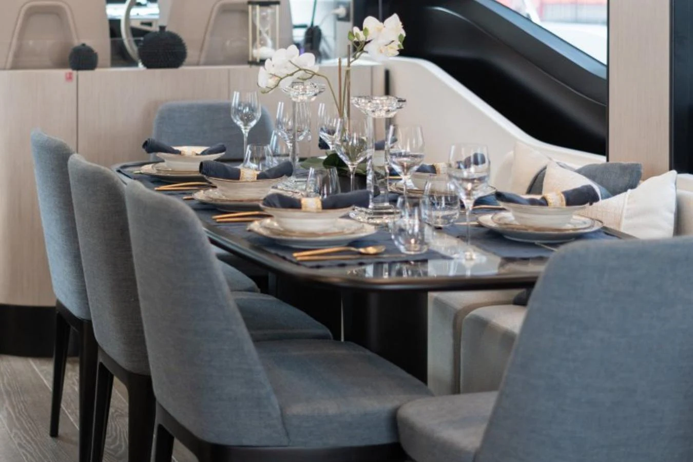 The yacht's dining area features a beautifully set table with elegant tableware and comfortable seating. aboard TOPAZ Yacht for Sale