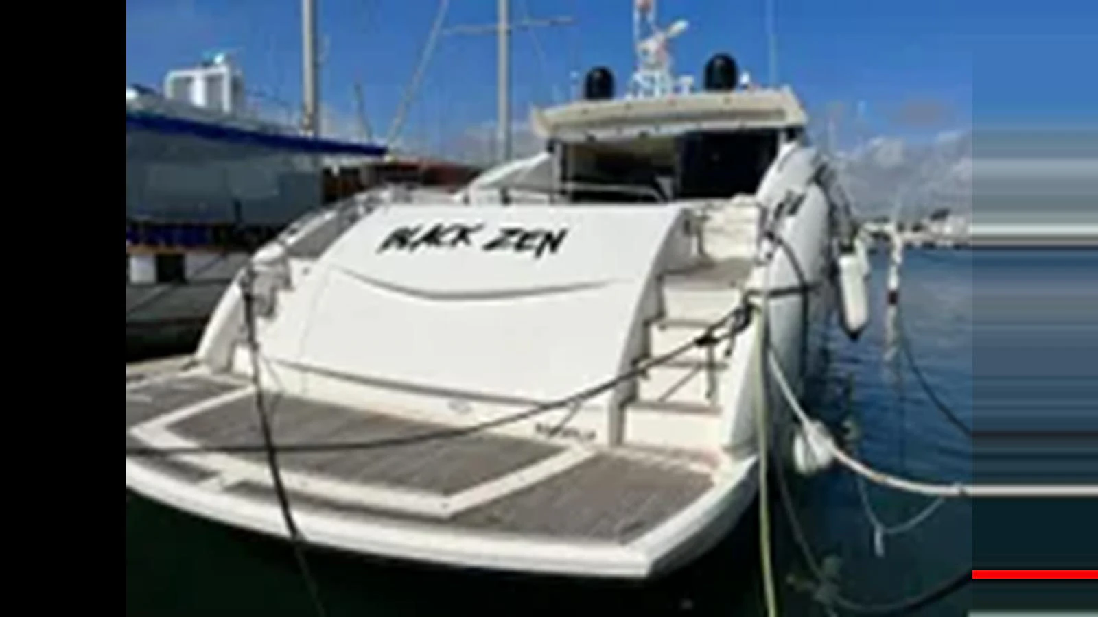 The yacht is docked at the marina, showcasing its sleek stern design. aboard 2006 SUNSEEKER PREDATOR 82 Yacht for Sale