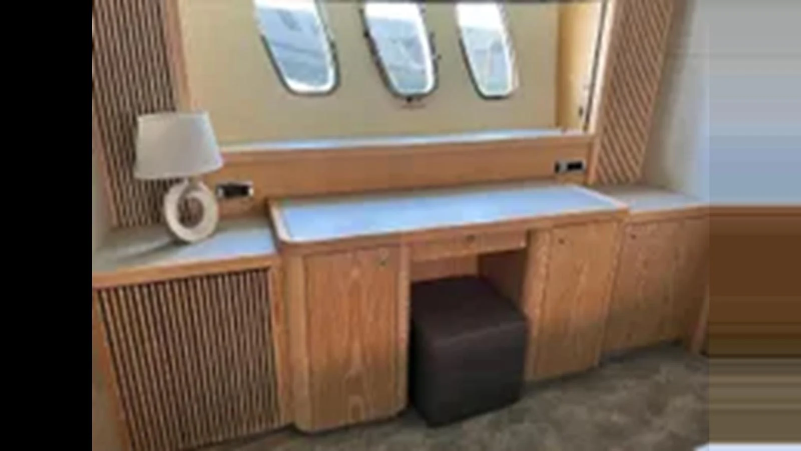 The yacht's interior features a stylish vanity area with ample storage and natural light from the windows. aboard 2006 SUNSEEKER PREDATOR 82 Yacht for Sale