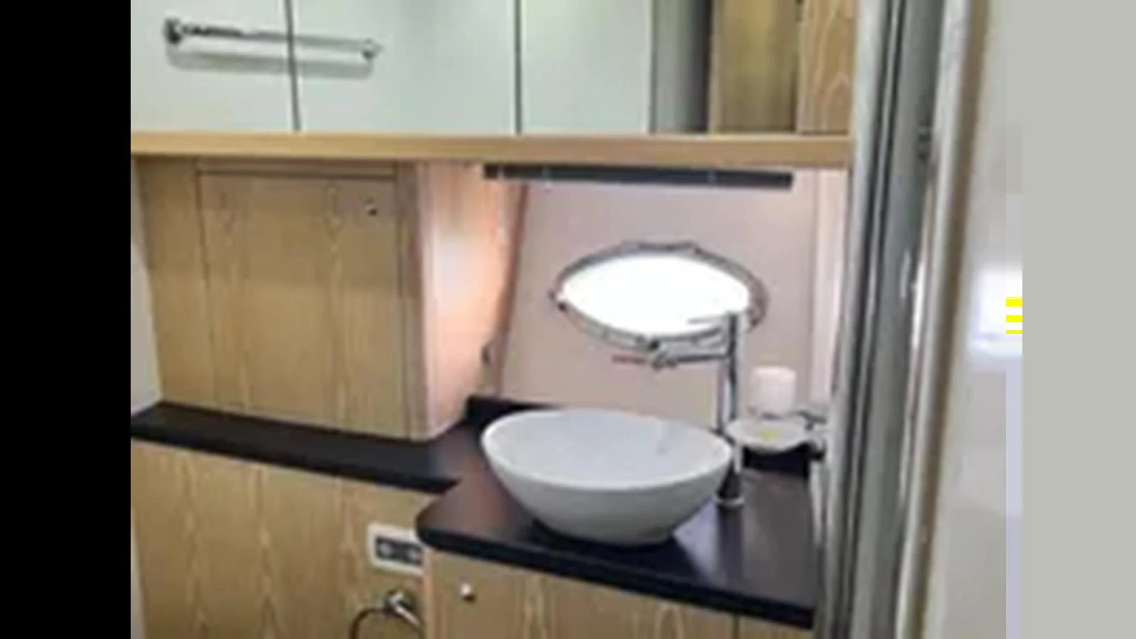 A modern yacht bathroom with a sleek sink and ample storage. aboard 2006 SUNSEEKER PREDATOR 82 Yacht for Sale