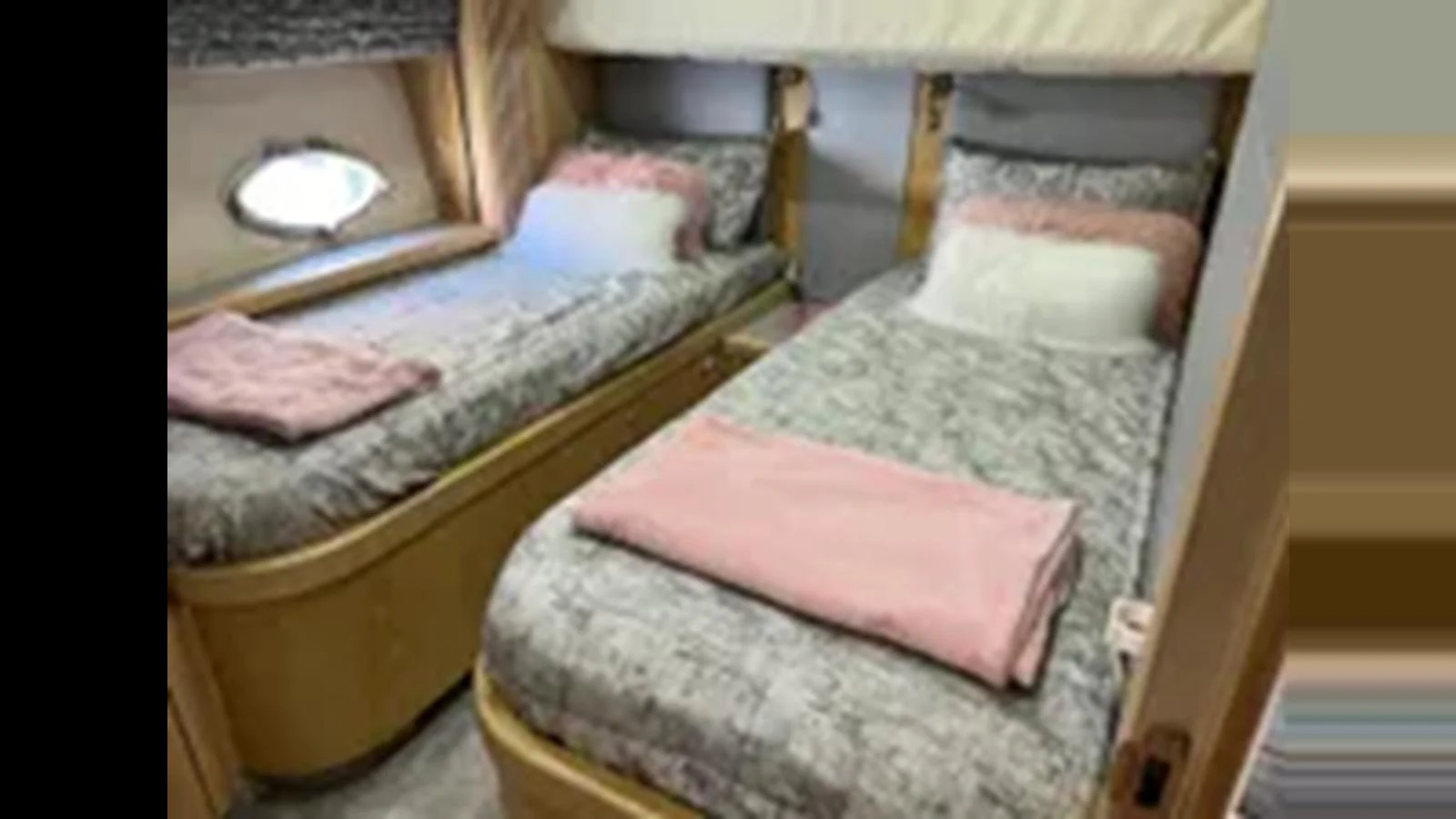 The twin stateroom features two cozy single beds with soft linens and a small window for natural light. aboard 2006 SUNSEEKER PREDATOR 82 Yacht for Sale