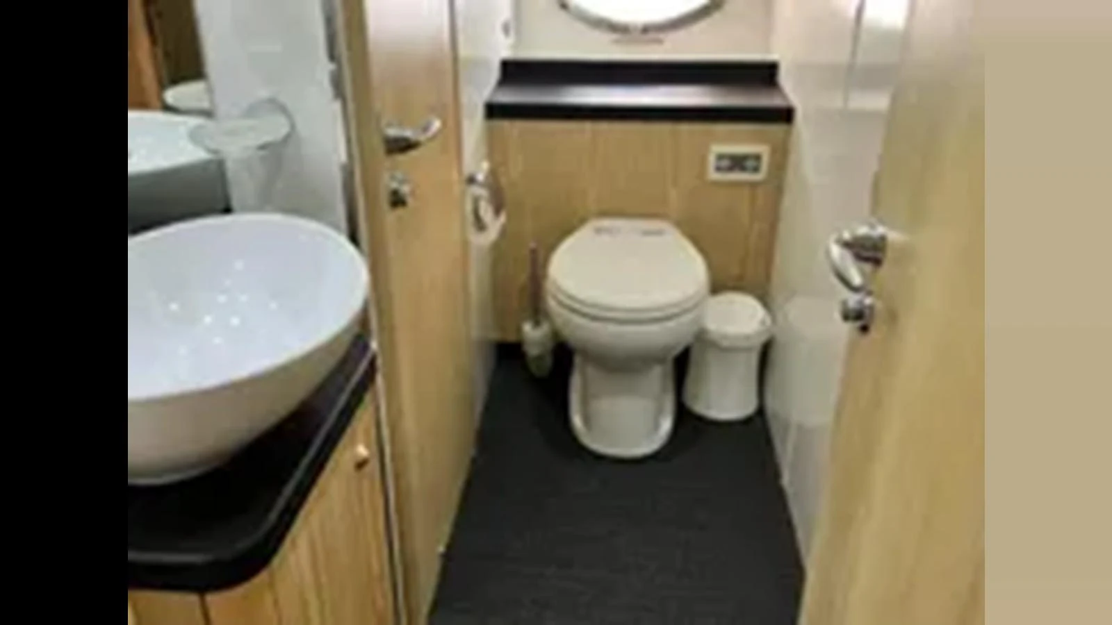 The yacht's head features modern fixtures and a clean design. aboard 2006 SUNSEEKER PREDATOR 82 Yacht for Sale