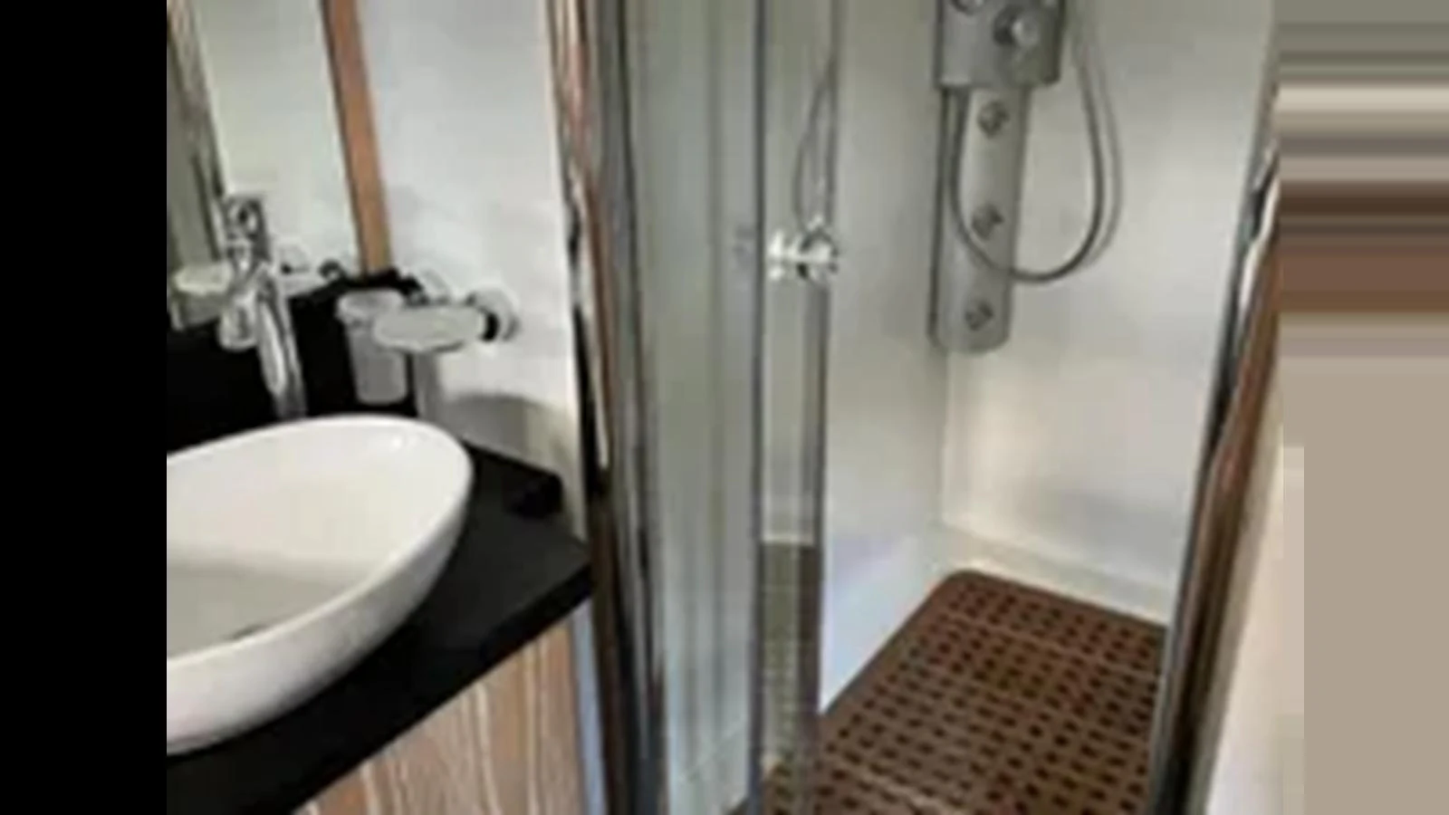 A modern yacht bathroom featuring a sleek shower and a stylish sink. aboard 2006 SUNSEEKER PREDATOR 82 Yacht for Sale