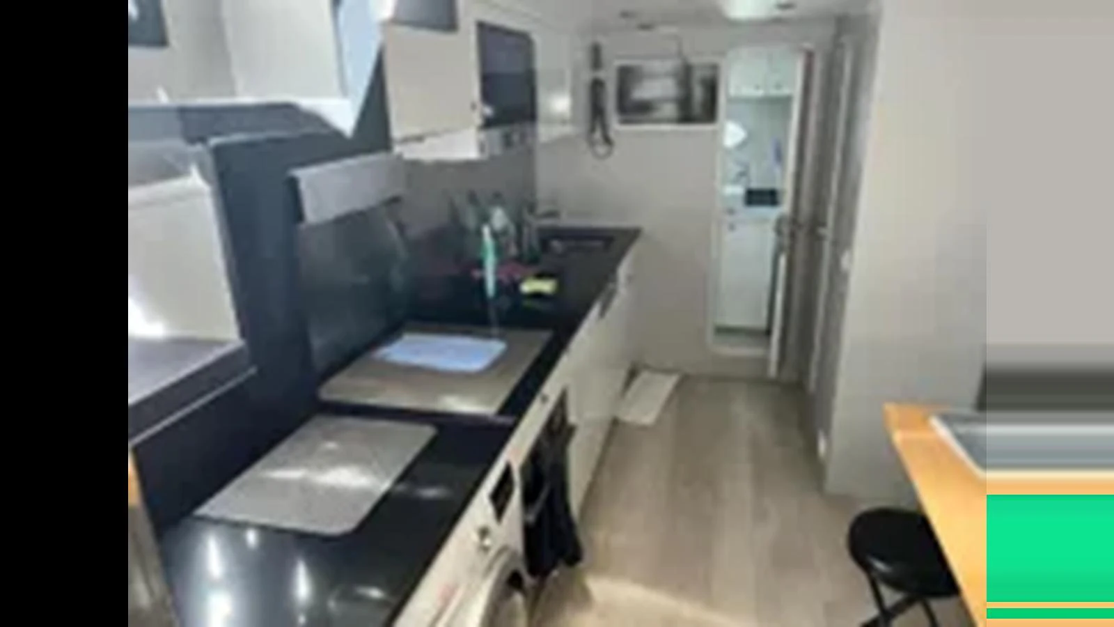 The modern galley features sleek black countertops and ample storage space. aboard 2006 SUNSEEKER PREDATOR 82 Yacht for Sale