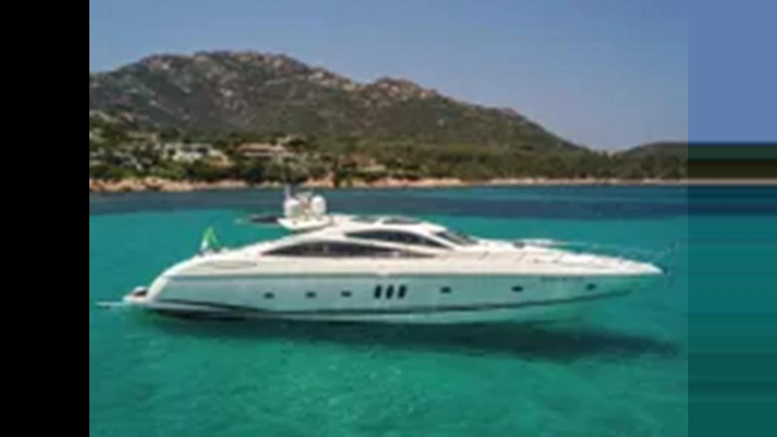 A sleek white yacht glides gracefully on turquoise waters against a backdrop of lush hills. aboard 2006 SUNSEEKER PREDATOR 82 Yacht for Sale