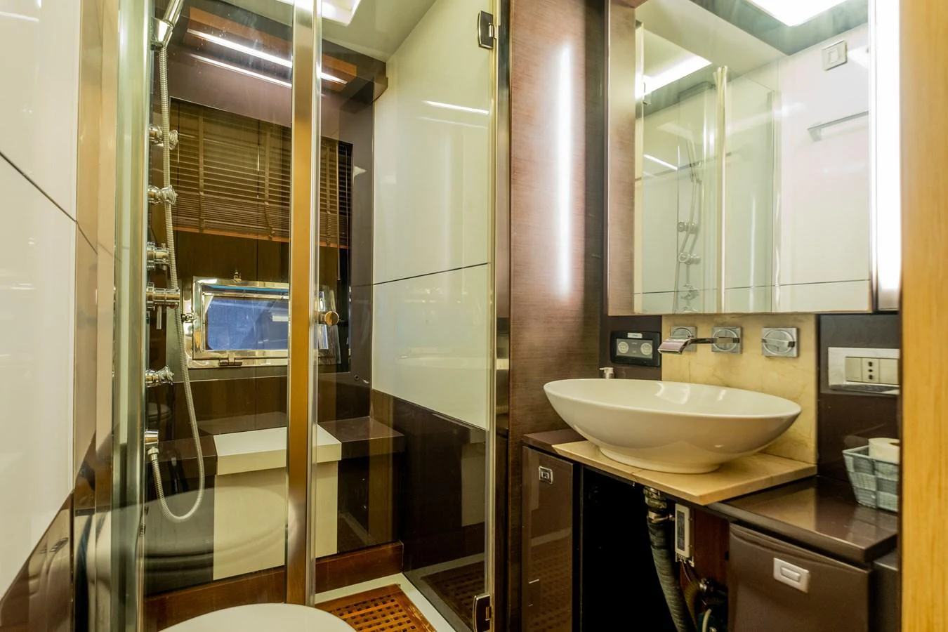 a bathroom with a sink and a mirror aboard CANADOS 90 #4 Yacht for Sale