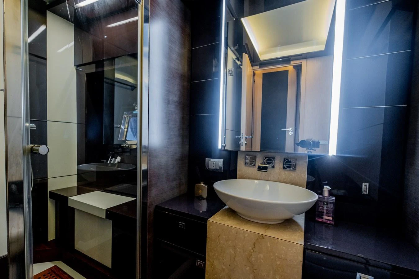 a bathroom with a sink and a mirror aboard CANADOS 90 #4 Yacht for Sale