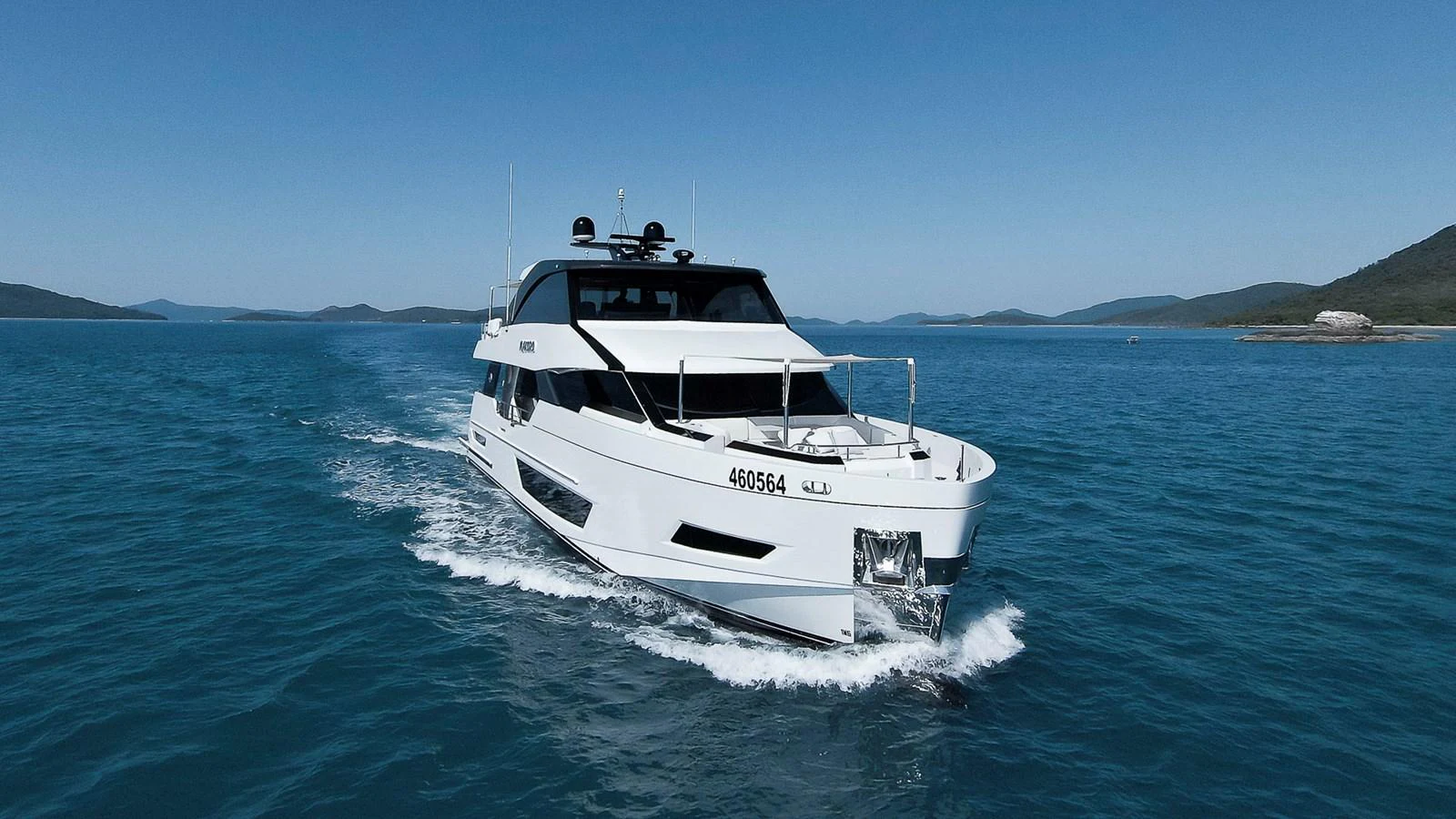 A sleek yacht cruises through clear blue waters, showcasing its modern design and luxurious appeal. aboard MAKORO Yacht for Sale