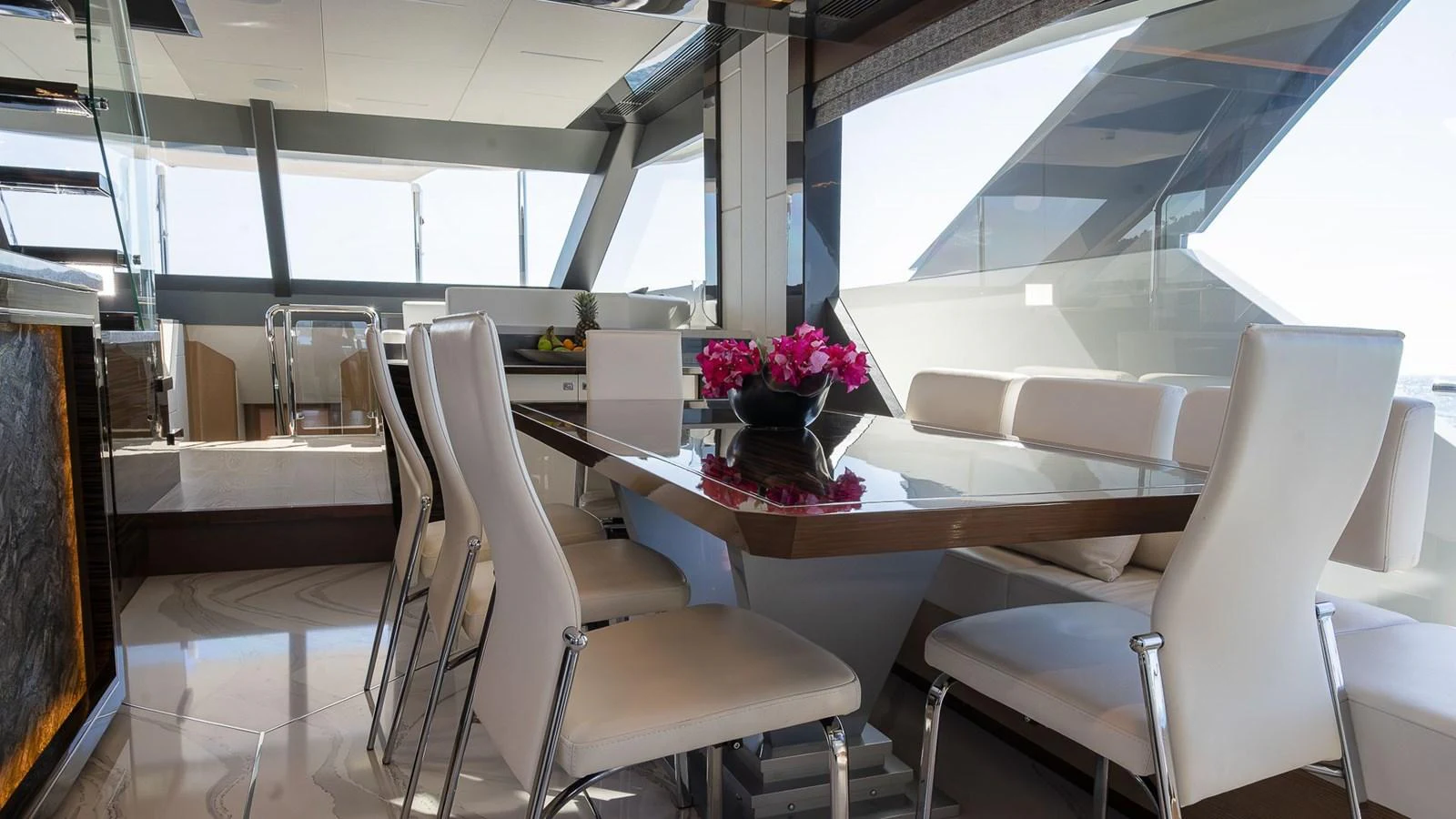 The yacht's dining area features a sleek, modern design with ample natural light. aboard MAKORO Yacht for Sale