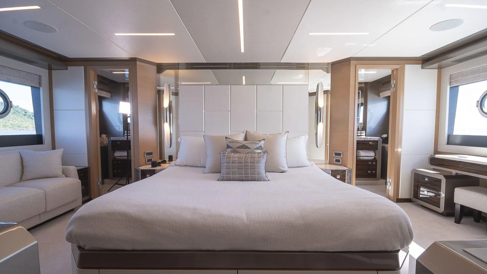 The master stateroom features a spacious bed with elegant decor and ample natural light. aboard MAKORO Yacht for Sale