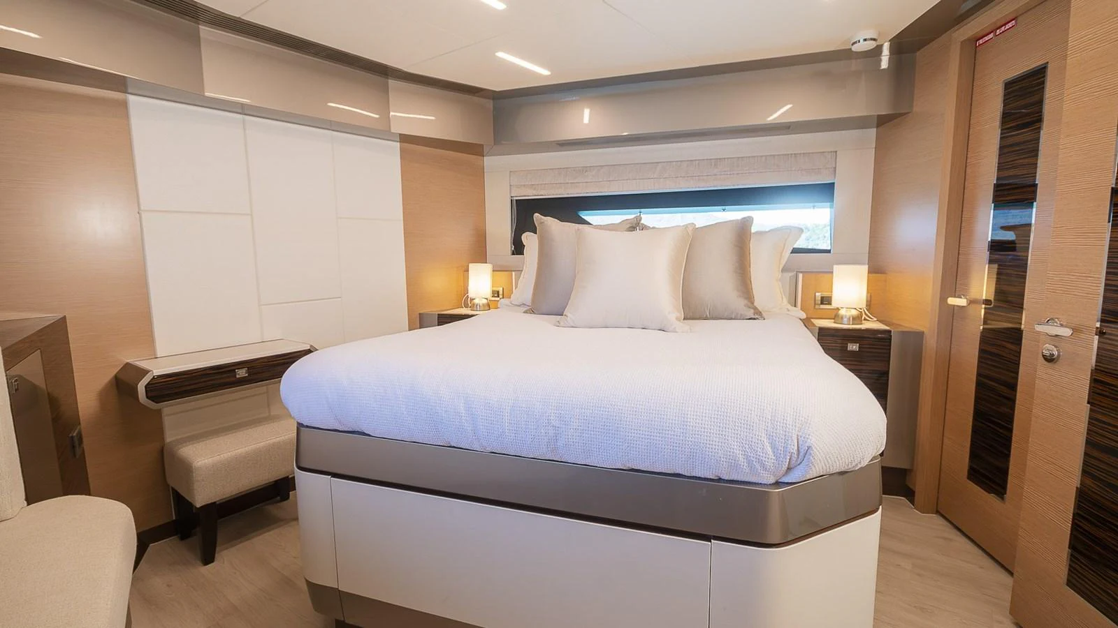 The master stateroom features a spacious bed with elegant bedding and modern furnishings. aboard MAKORO Yacht for Sale