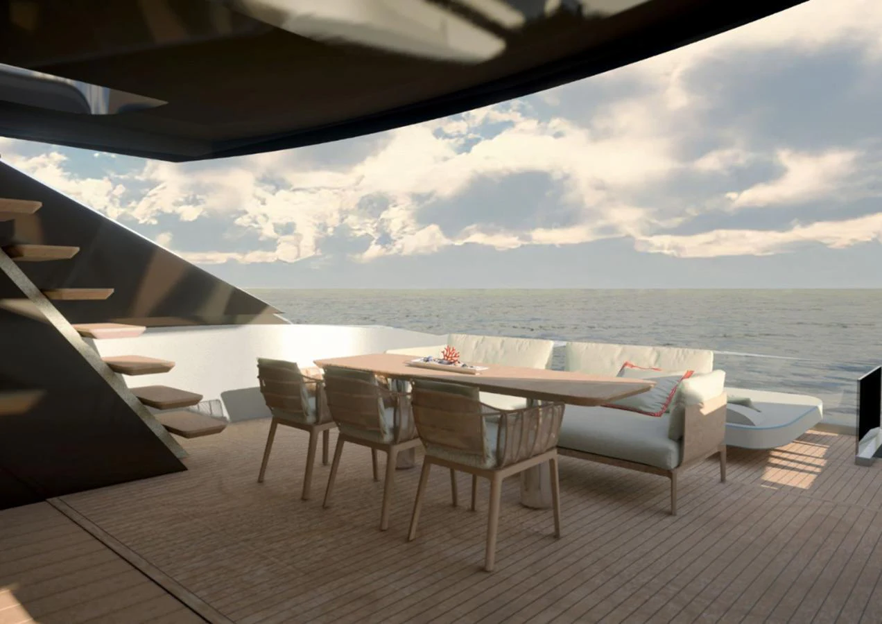 The aft deck features a stylish dining area with a wooden table and comfortable seating, perfect for enjoying meals with a view of the sea. aboard NEW Yacht for Sale